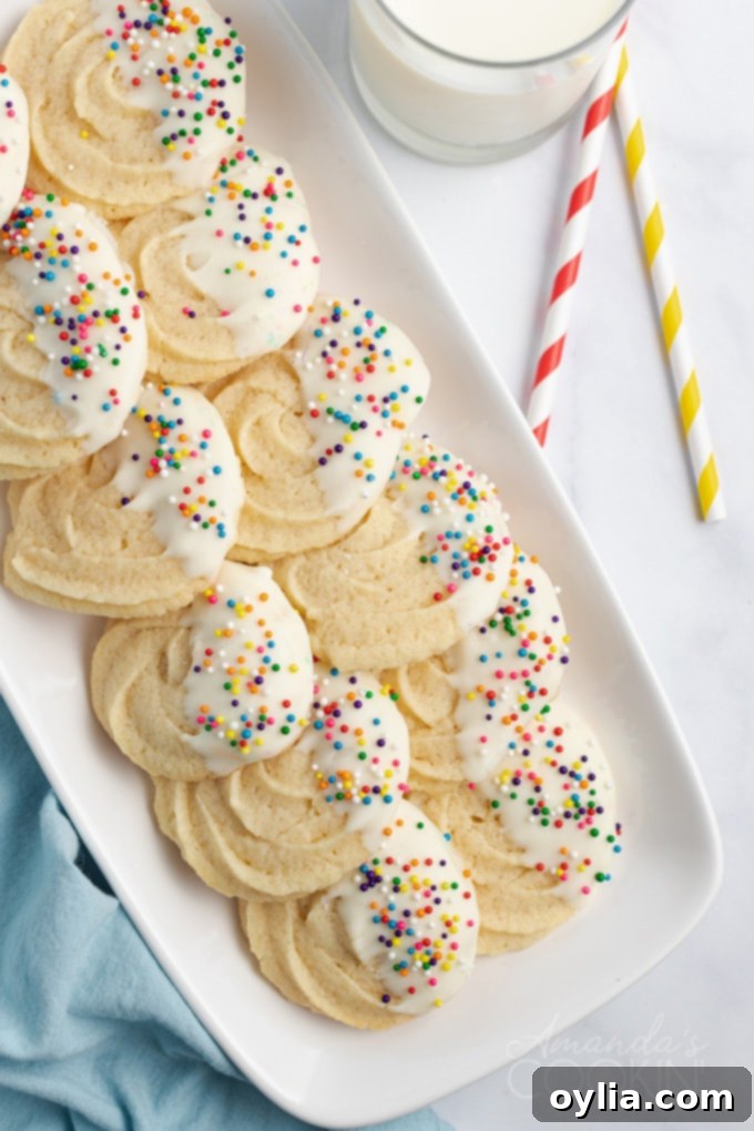 Butter Cookies are delicious and soft and easy to make. Slice and baking, roll out and cut with cookie cutters, or pipe through a tip for pretty cookies! A festive arrangement of chocolate-dipped butter cookies on a platter, ready for serving.