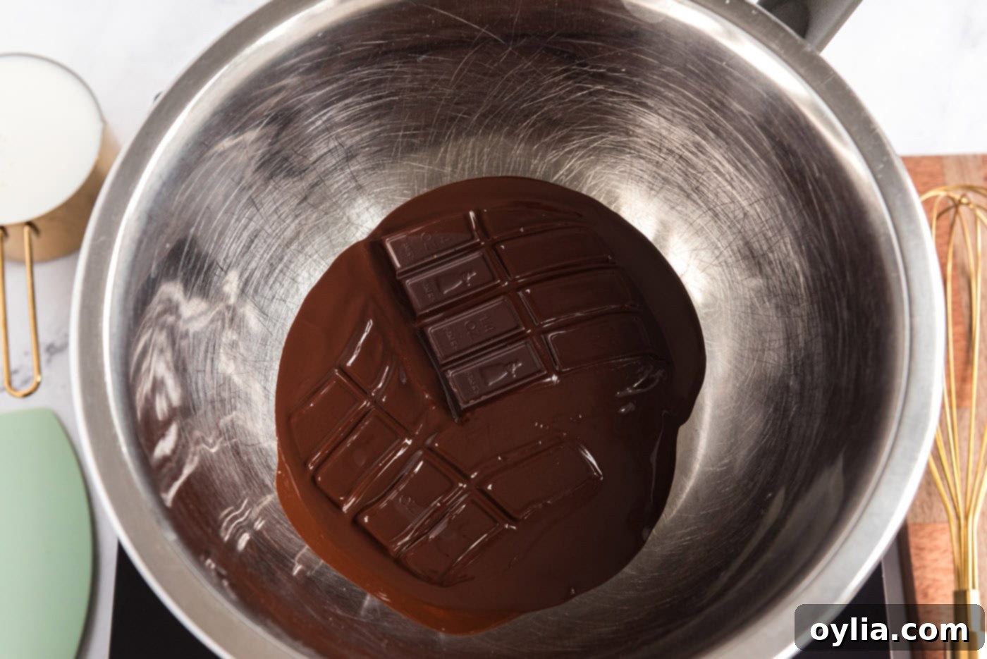 Melting unsweetened chocolate bars in a bowl over hot water in a double boiler setup