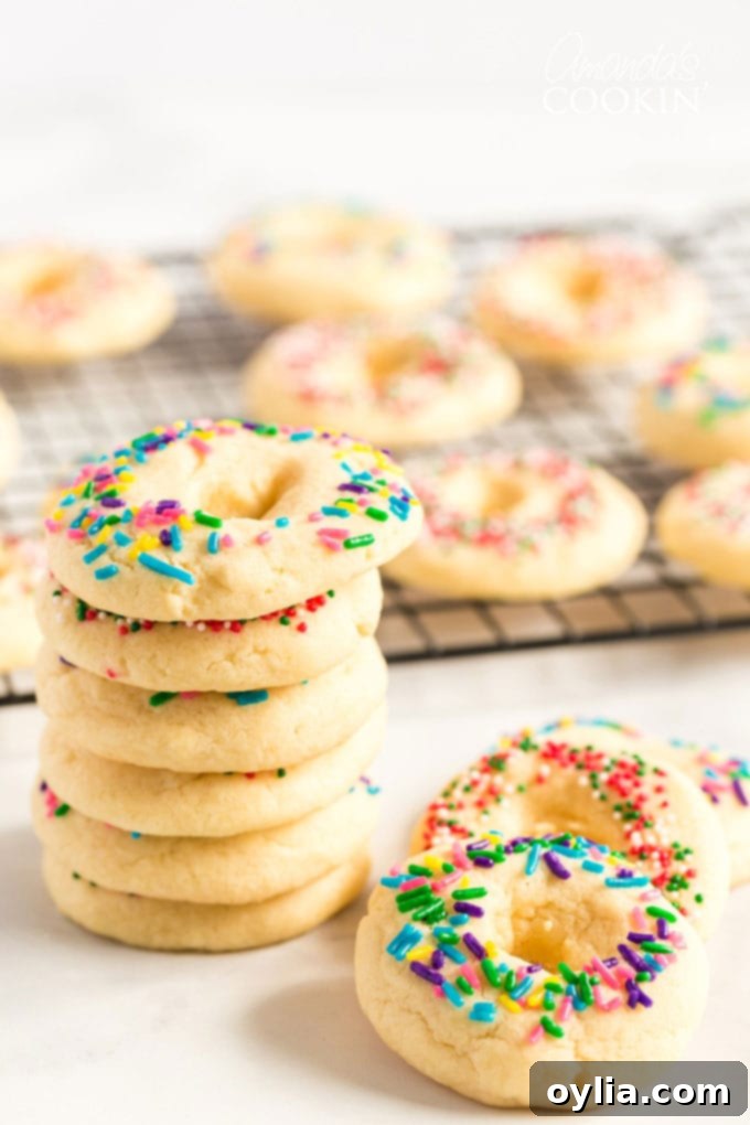 A delicious buttery sugar cookie with a pretty presentation. These soft cookies would be great for a birthday party, Cinco de Mayo celebrations, or just when you want a chewy sugar cookie. Stack of Mexican cookies with colorful sprinkles on a white plate