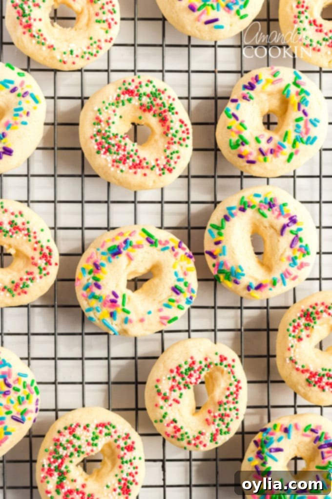 A delicious buttery sugar cookie with a pretty presentation. These soft cookies would be great for a birthday party, Cinco de Mayo celebrations, or just when you want a chewy sugar cookie. Freshly baked Mexican cookie rings cooling on a wire rack