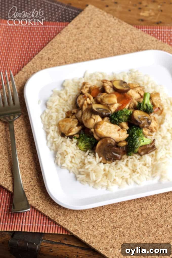 Chicken stir fry with vegetables on a bed of white rice