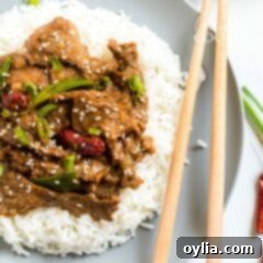 plate of mongolian beef with chop sticks