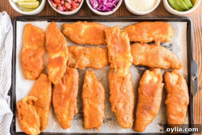 fried fish draining on paper towels