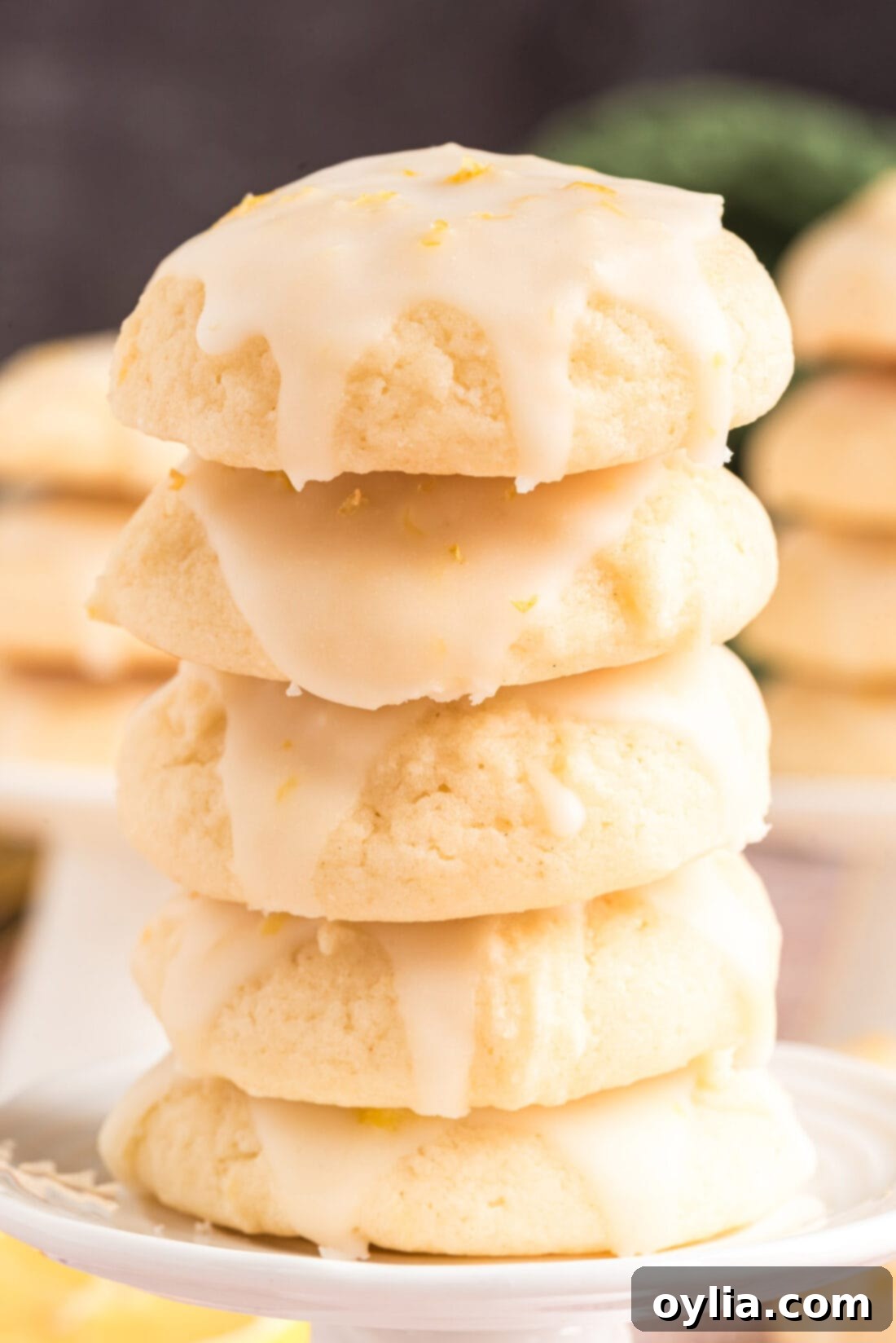 A perfectly arranged stack of three glazed Lemon Drop Cookies, highlighting their delicious texture and vibrant color.