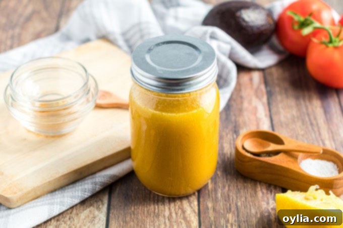 Mason jar filled with ingredients for Cobb Salad dressing before shaking