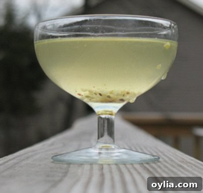 A glass of vibrant green pickle juice, inviting reuse in various culinary applications.