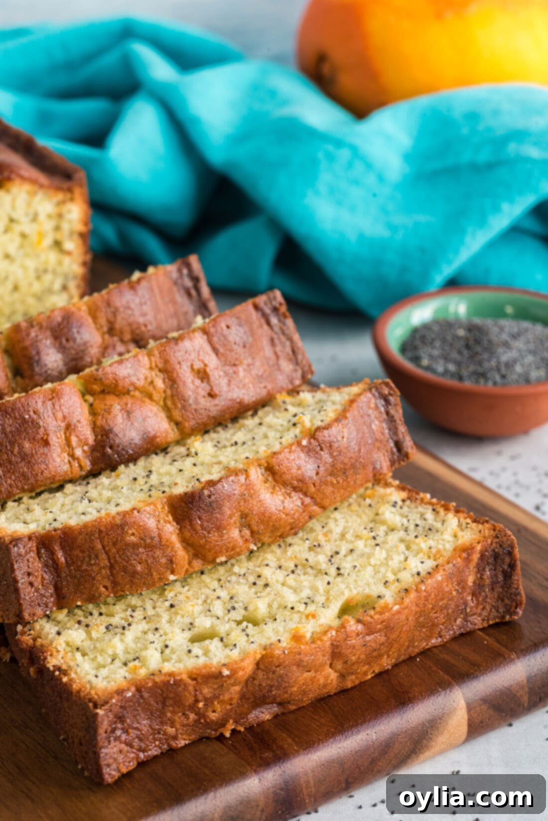 Orange Poppy Seed Pound Cake sliced up, showing the texture and glaze