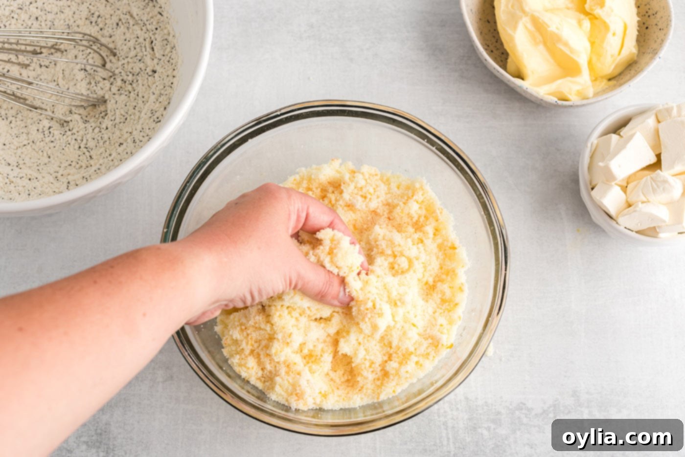 hand blending sugar and orange zest in a bowl for maximum flavor