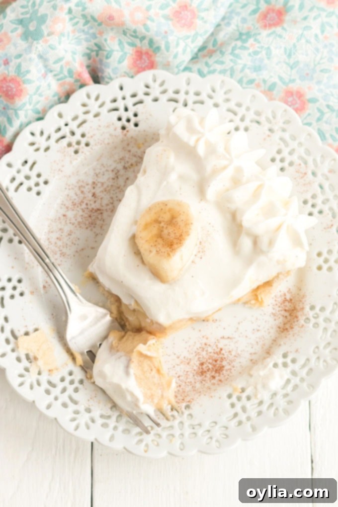 slice of banana cream pie with a fork on the plate