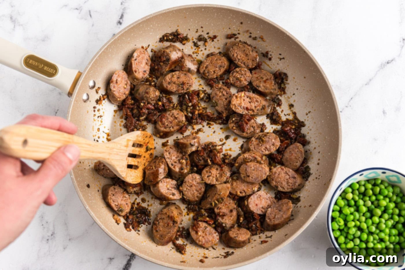 sliced Italian sausage added to skillet with sun dried tomato mixture