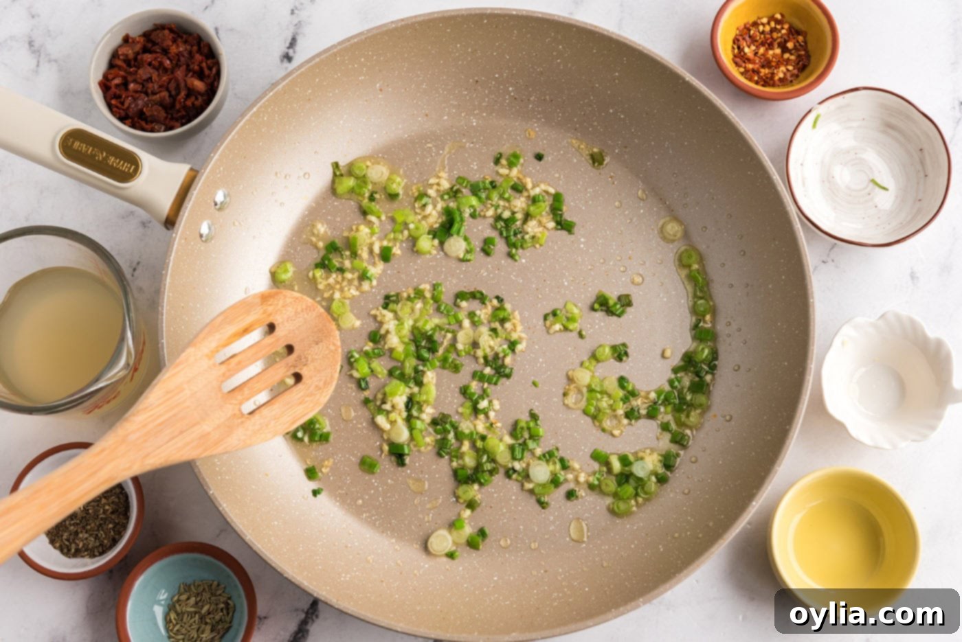 sauteeing garlic and scallions in a skillet