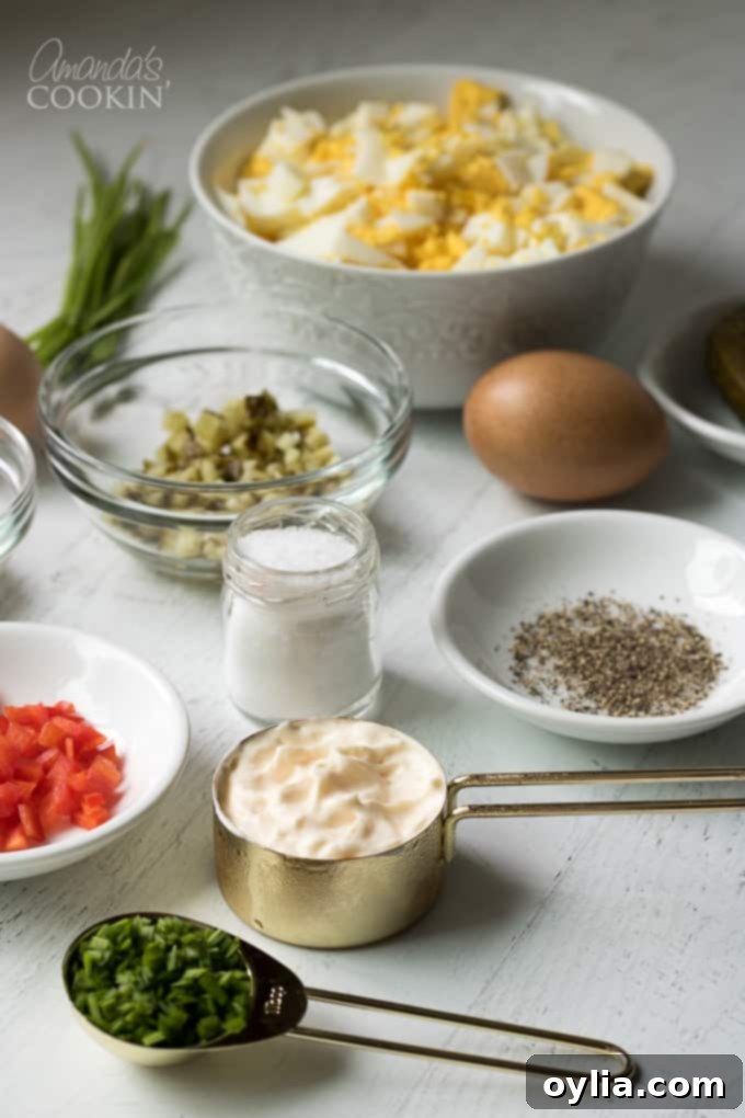 All fresh ingredients for egg salad displayed on a cutting board