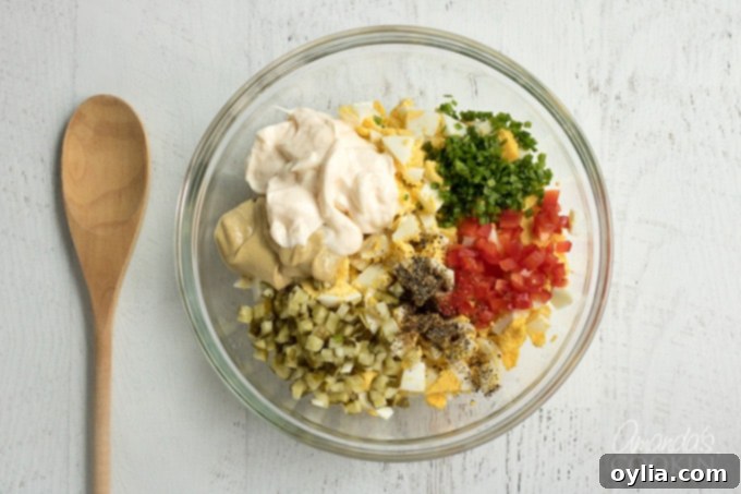 Step 1: Combine chopped eggs, mayonnaise, and Dijon mustard in a bowl.
