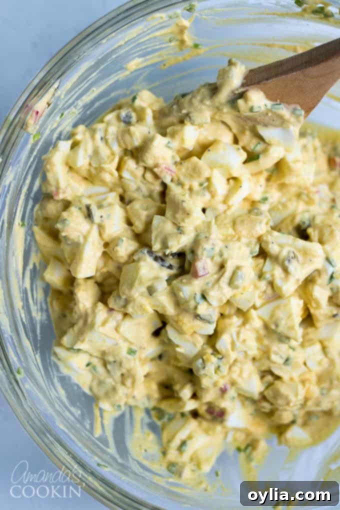 Mixing all ingredients for the creamy and flavorful egg salad recipe