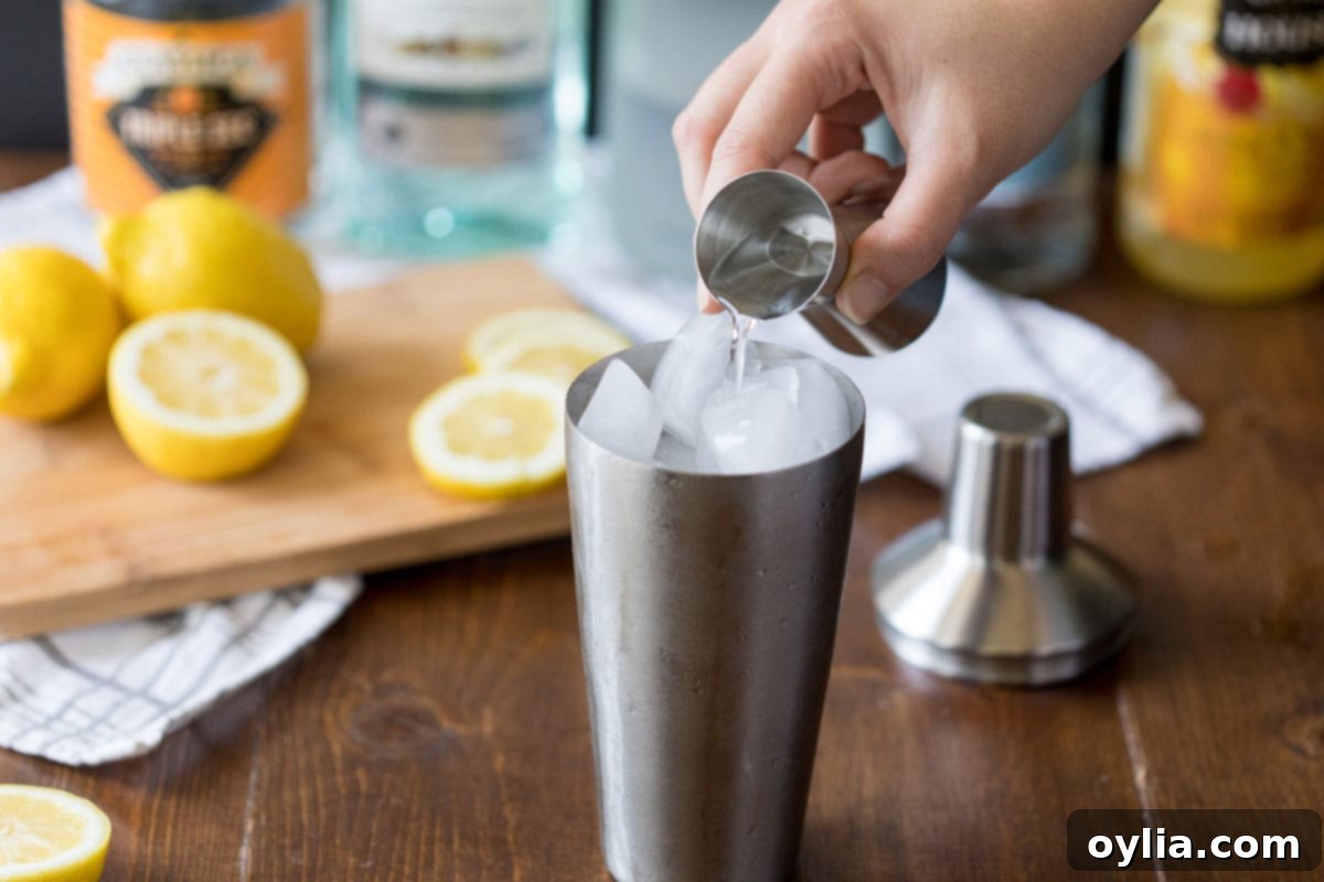 adding vodka to a cocktail shaker