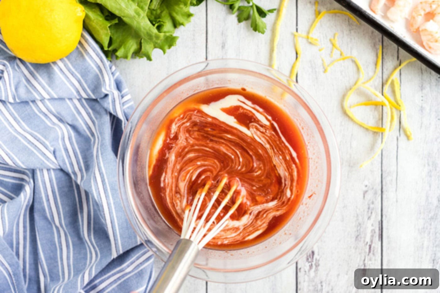 Whisking cocktail sauce ingredients in a bowl