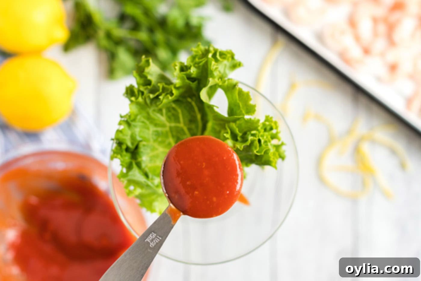 adding cocktail sauce to martini glass
