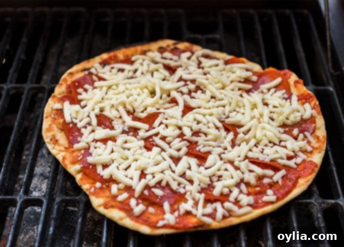 pizza cooking on a gas grill