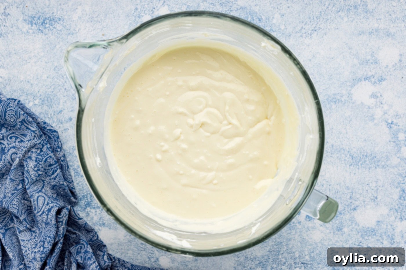 cheesecake batter in the bowl of a stand mixer