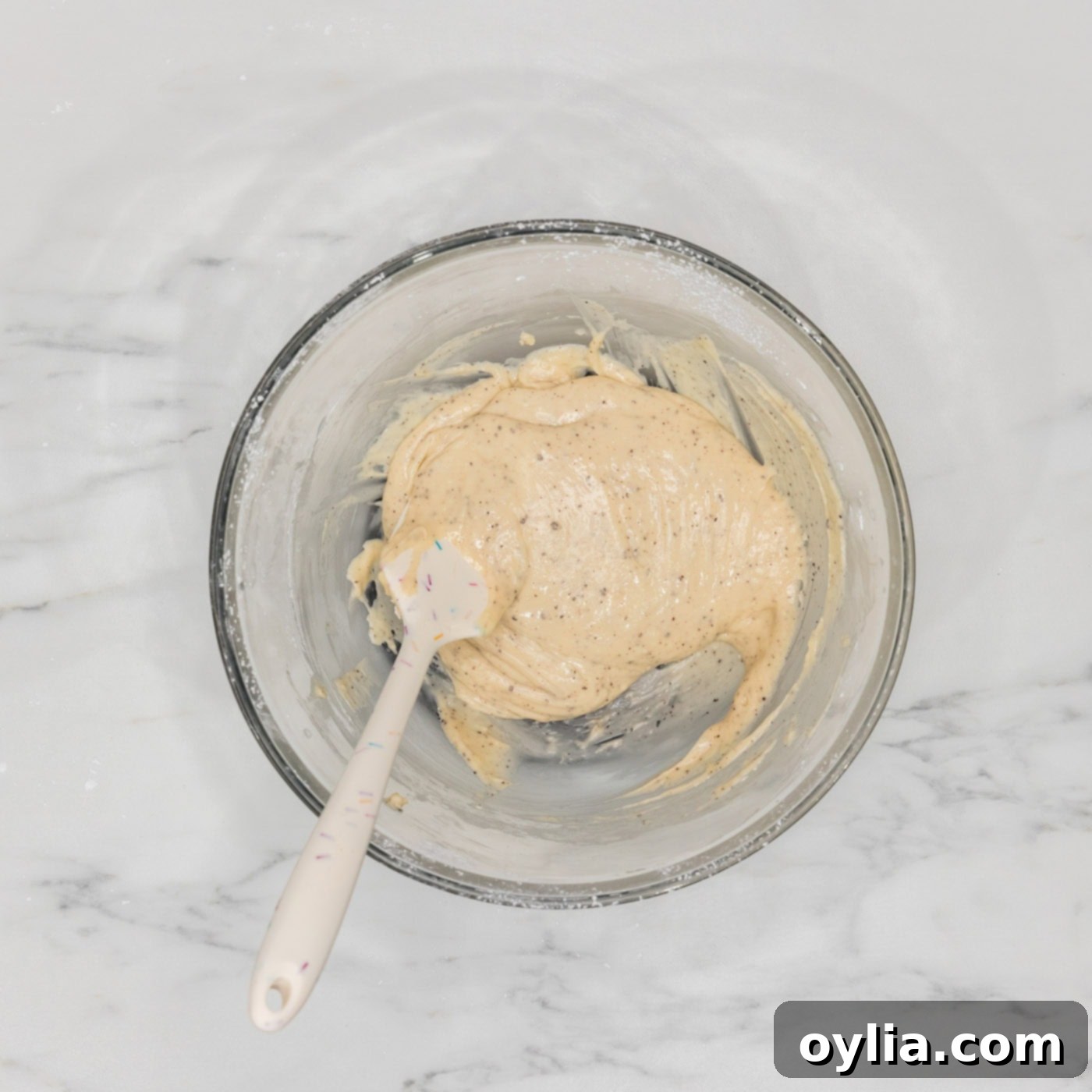 brown butter glaze in a bowl with a rubber spatula