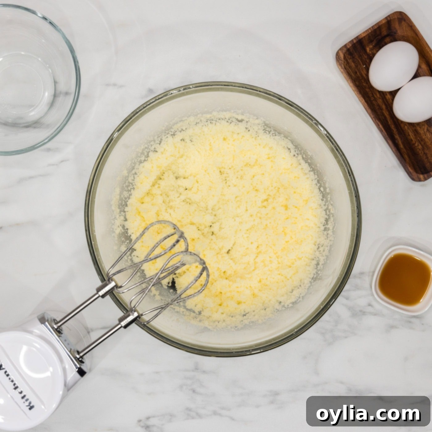 shortening and sugar creamed in a bowl with a hand mixer