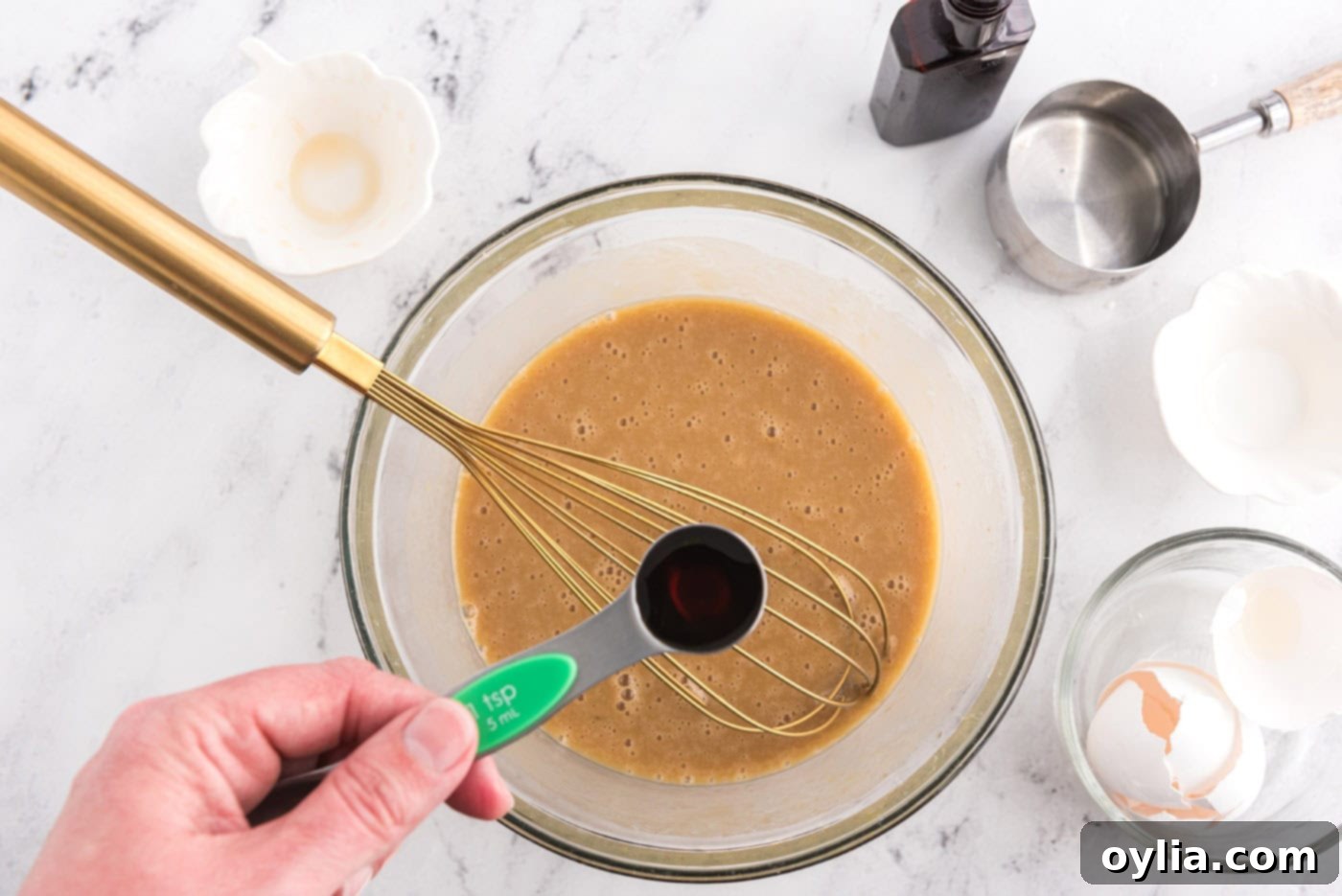 adding vanilla to wet ingredients for banana upside down muffins