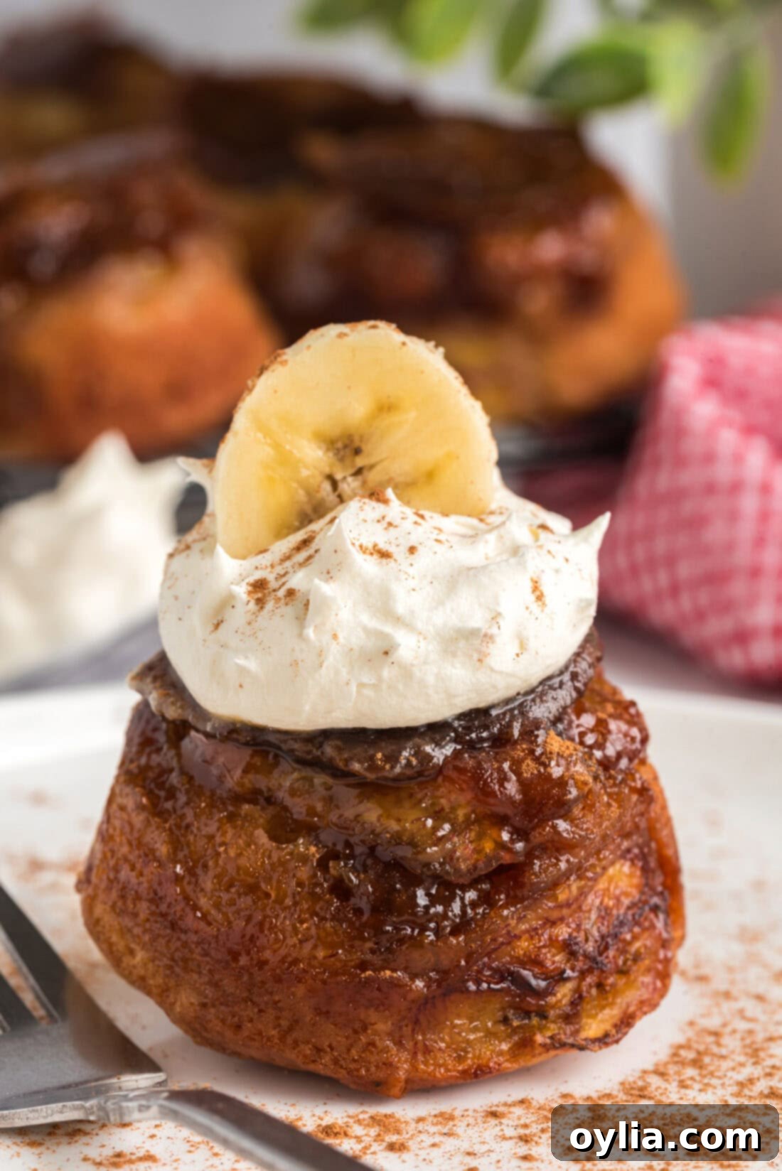 Caramelized Banana Muffins 3 Banana Upside Down Muffin topped with whipped cream and a banana slice