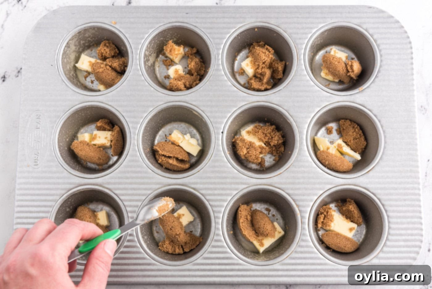 Caramelized Banana Muffins 5 butter and dark brown sugar in wells of a muffin pan