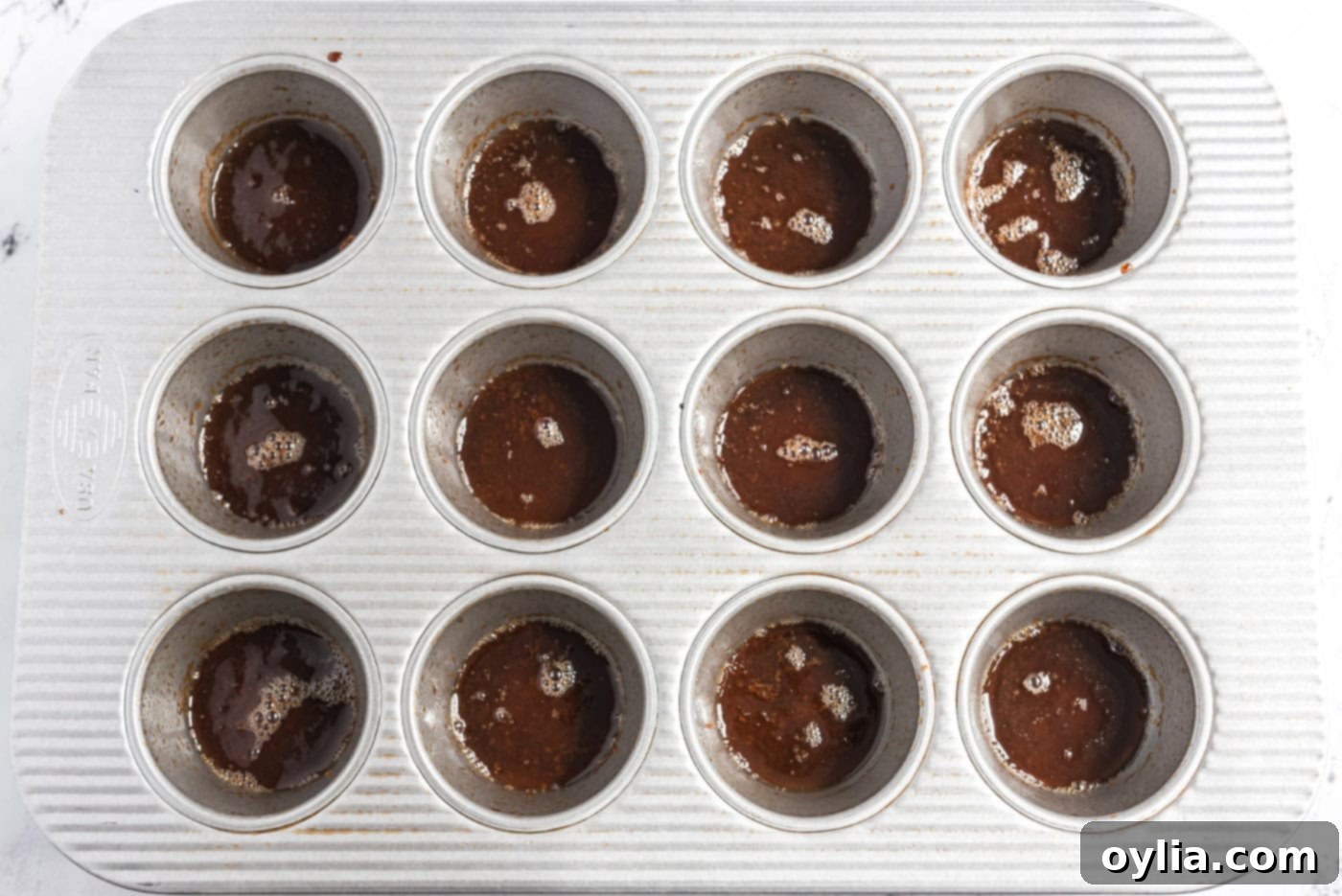 melted butter and brown sugar on bottoms of muffin pan