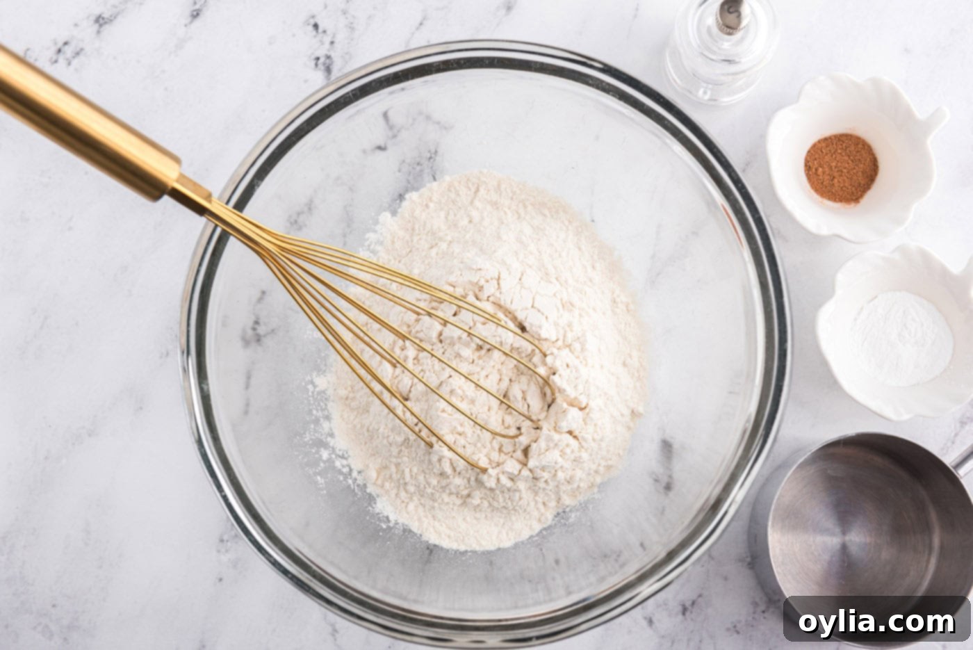 flour and dry ingredients with a whisk in a bowl