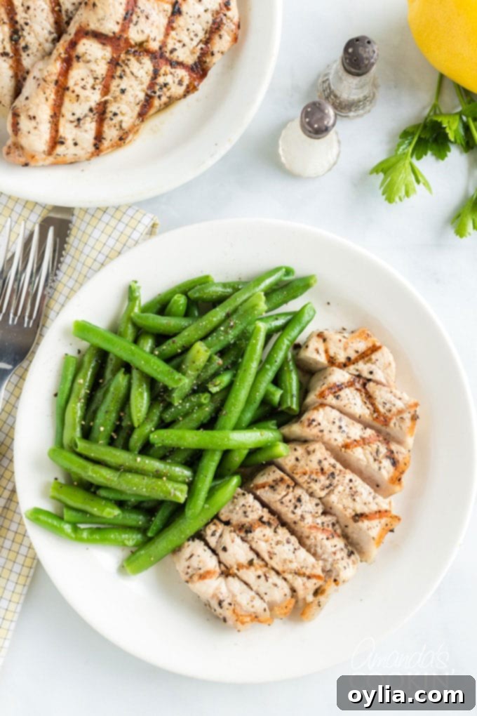 sliced pork chop on a plate with green beans