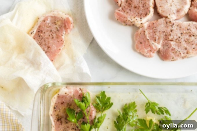 pork chops being dried off with paper towels