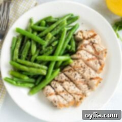 A plate of food with pork chops and green beans