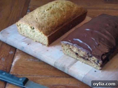 Two loaves of golden brown Morning Glory Zucchini Bread cooling on a wire rack.
