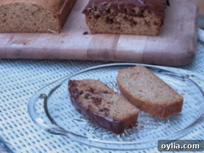 A slice of Morning Glory Zucchini Bread, showing its moist texture and golden crust.