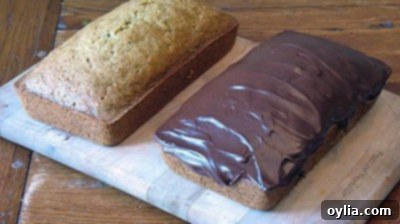 Moist Zucchini Loaf 2 A photo of two loaves of morning glory zucchini bread, one sliced.