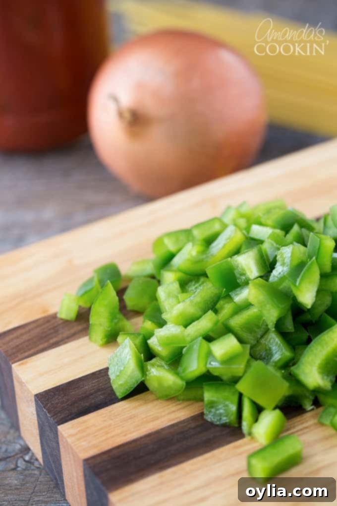 Chopped green bell pepper on a wooden cutting board.