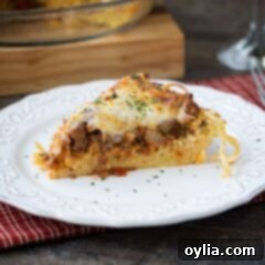 A slice of spaghetti pie on a white plate.