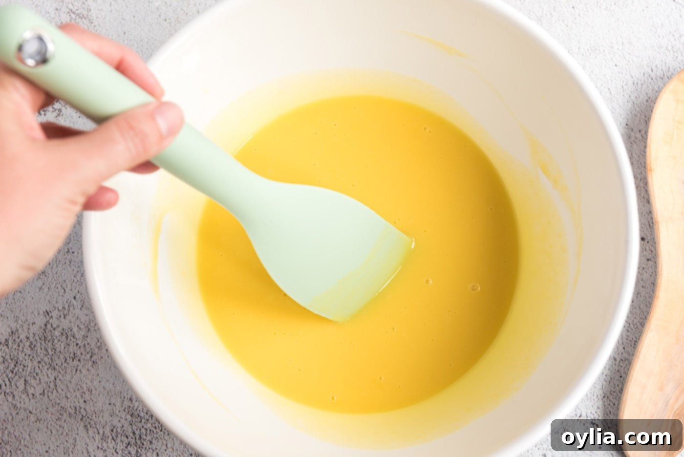Egg mixture being stirred with white chocolate pieces