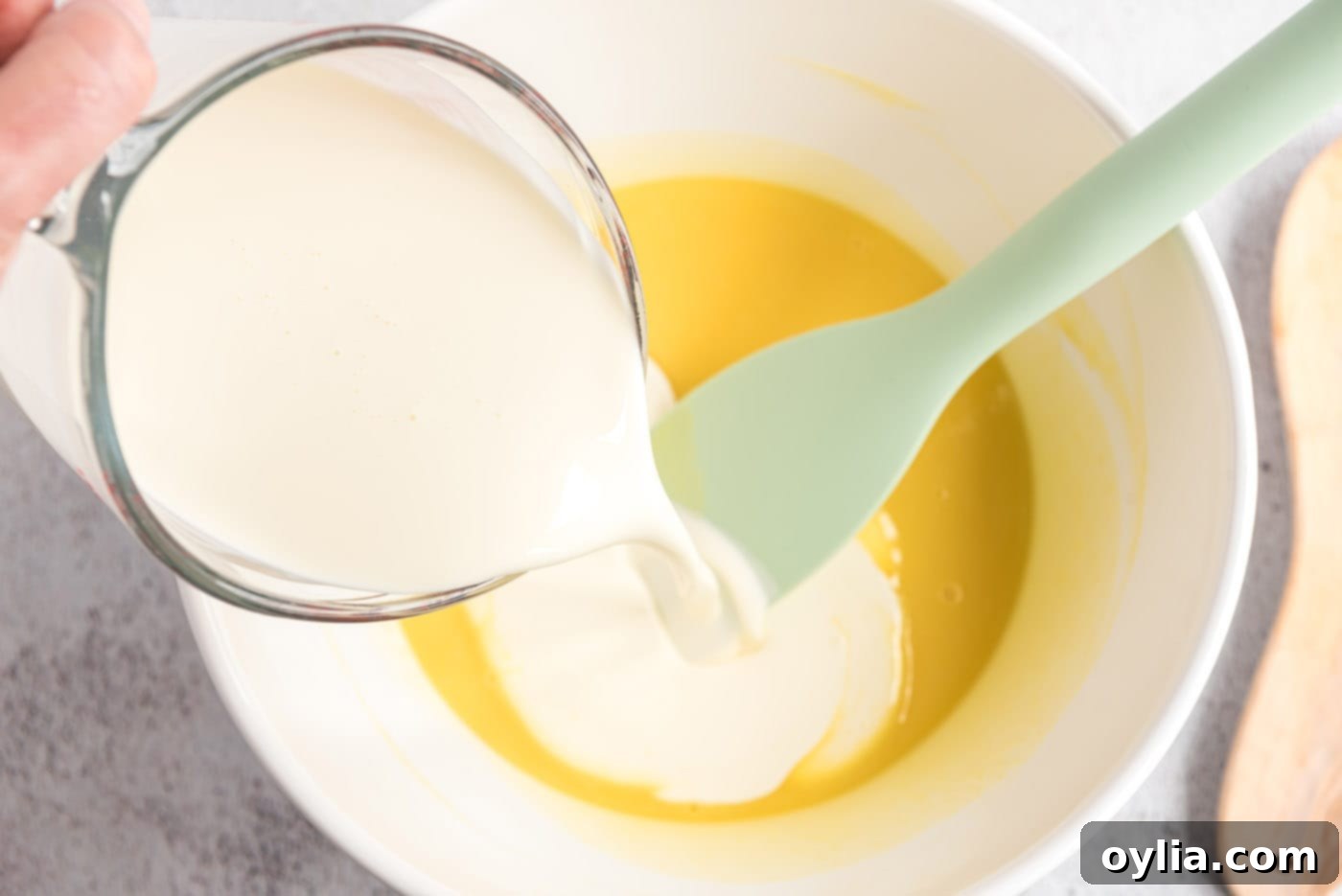 Cream being poured into the custard