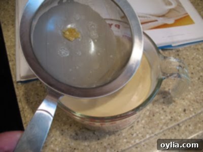 A photo of the ice cream mixture strained into a measuring cup.