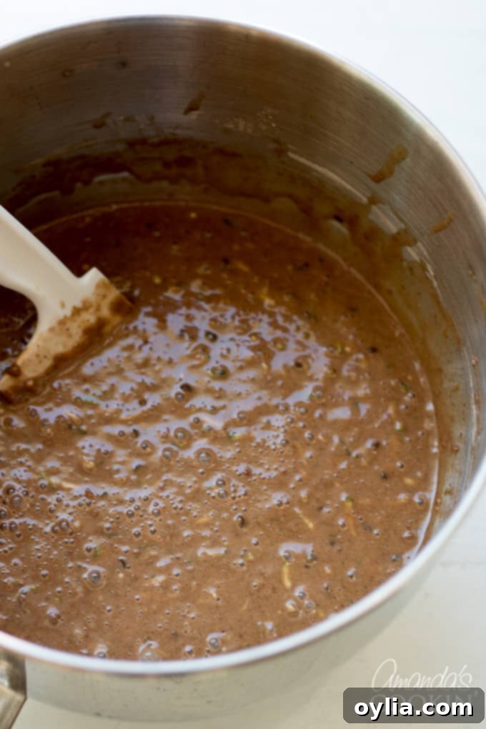 Finished chocolate zucchini bread batter in loaf pans with topping