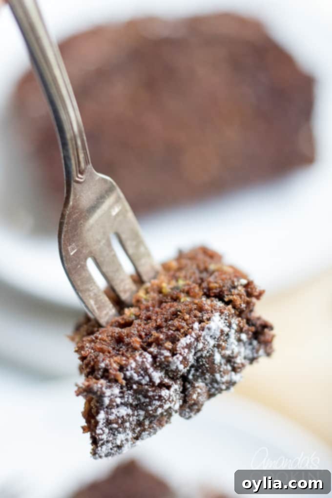 A fork taking a piece of chocolate zucchini bread