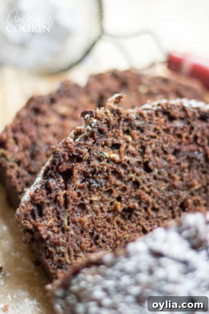 Slices of rich chocolate zucchini bread on a cutting board