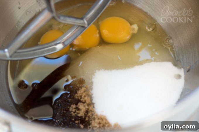 Wet ingredients mixing in a stand mixer for chocolate zucchini bread