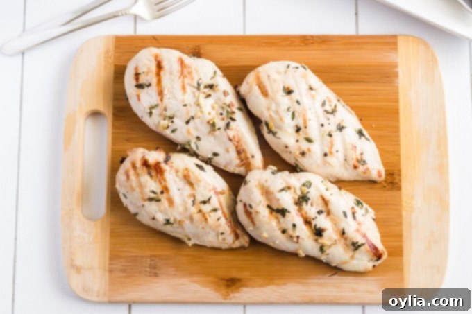 cooked grilled chicken on a cutting board