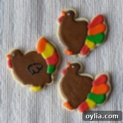 A photo of three thanksgiving turkey cookies.
