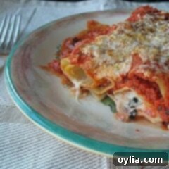 Savory Prosciutto Manicotti Bake 2 A close up photo of a serving of baked manicotti with prosciutto on a plate.