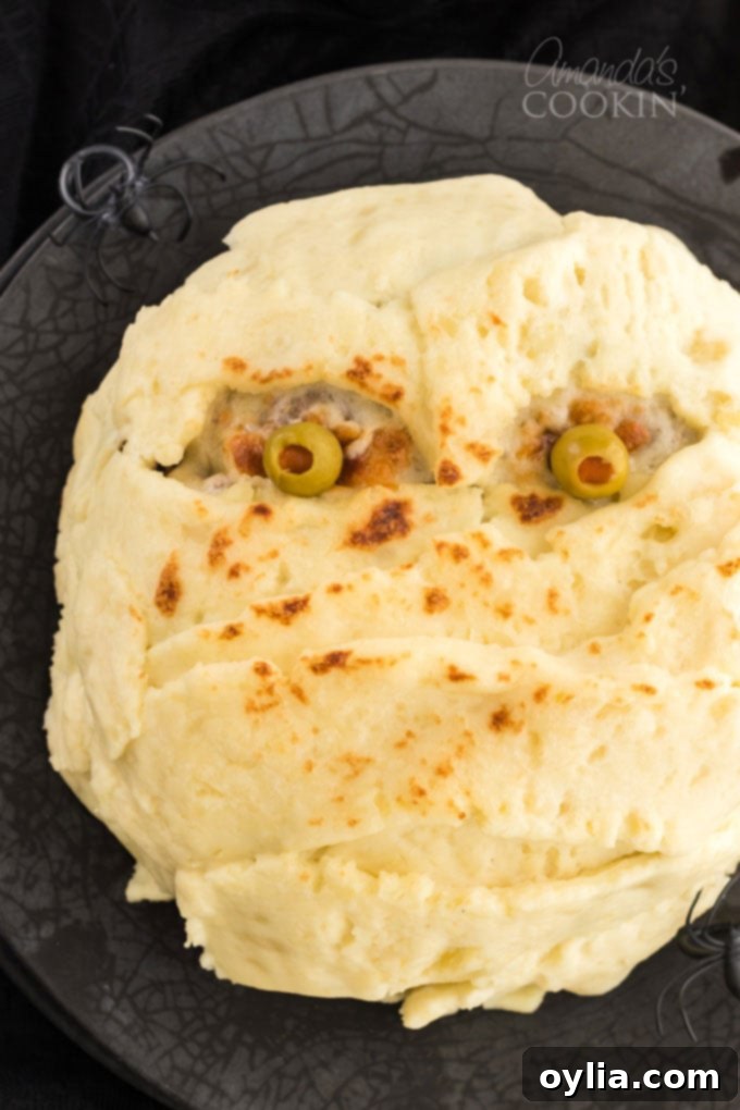 This Mummy Meatloaf is a super fun way to get kids to eat their dinner, perfect for Halloween! This mummy meatloaf is a great conversation starter! Mummy meatloaf on a plate, a fun and spooky Halloween dinner, garnished with ketchup blood