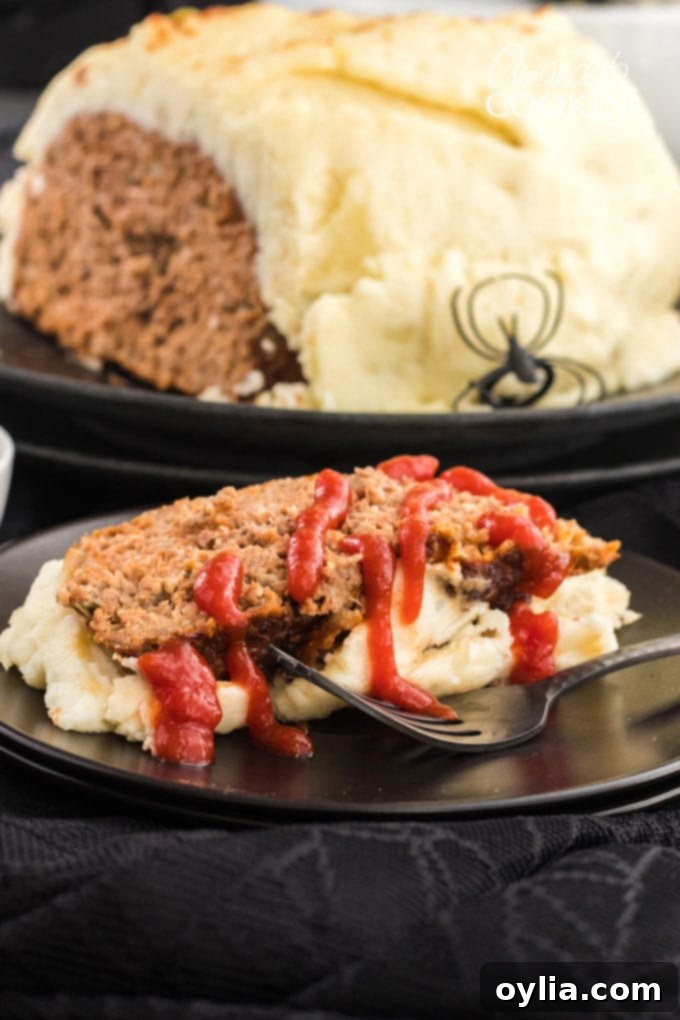 Enshrouded Meatloaf 4 A serving of mummy meatloaf on a plate, cut into a slice, with ketchup blood dribbled on top